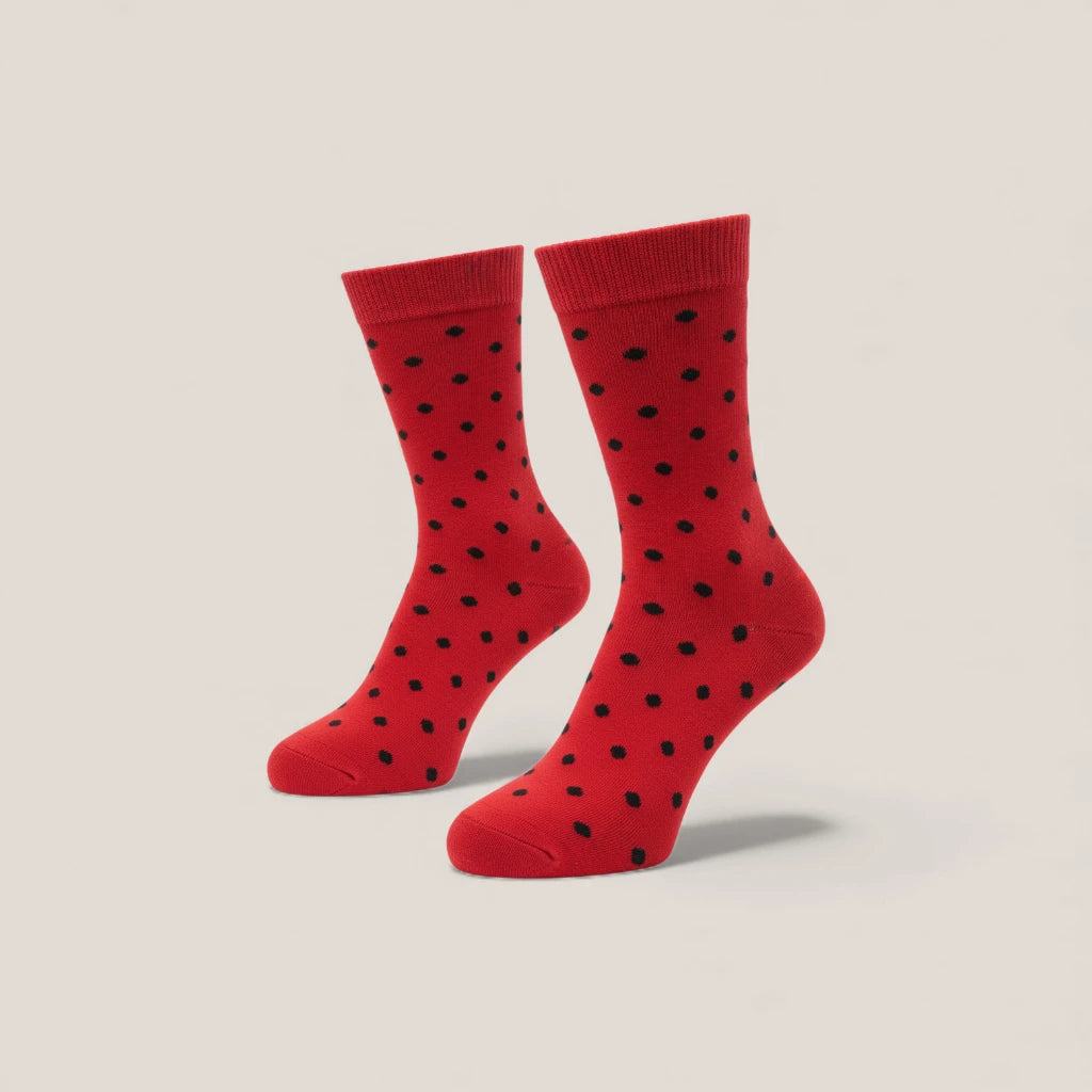 Red socks with black polka dots on a beige background