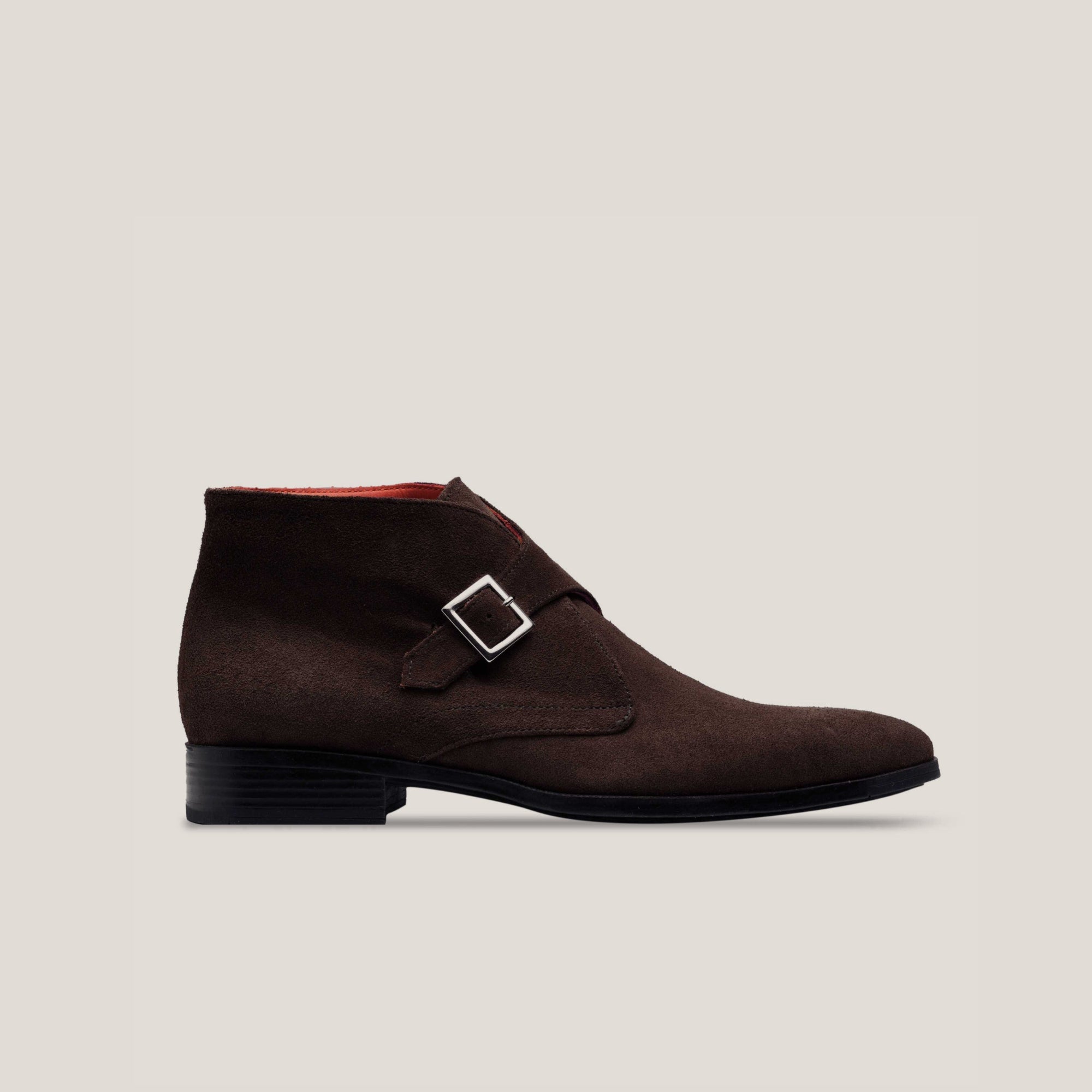 A dark brown suede monk strap boot with a single buckle and a low heel, displayed against a plain background.